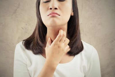 Woman scratching her neck