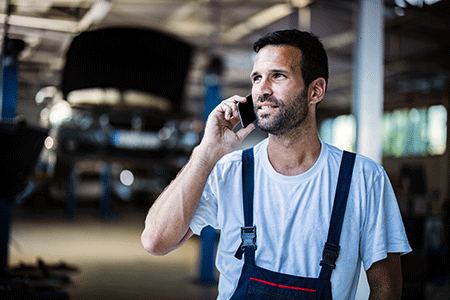 Mechanic talking on cell phone