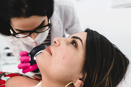 Dermatologist exams patient for skin cancer